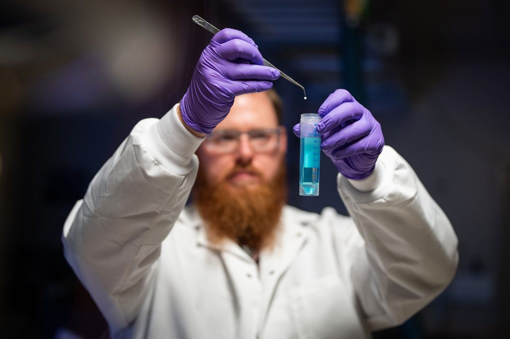 <strong>A TINY SOLUTION</strong>&nbsp;—&nbsp;Postdoctoral researcher Nathan Bays adds a tiny adsorbent particle to a solution containing an analyte of interest, such as PFAS, for analysis using their developed ISA-DESI technique.&nbsp;(Photo by Craig Fritz)