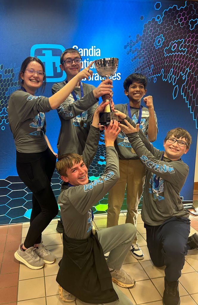 <strong>2026 DOE REGIONAL SCIENCE BOWL WINNERS</strong> — Los Alamos Middle School, Team 1 participants Norah Whitton, Ilamuhil Sasikumar, Evan Cunningham, Bodie Holmes and Alex Hovey show off their trophy. (Photo by Deb Menke)