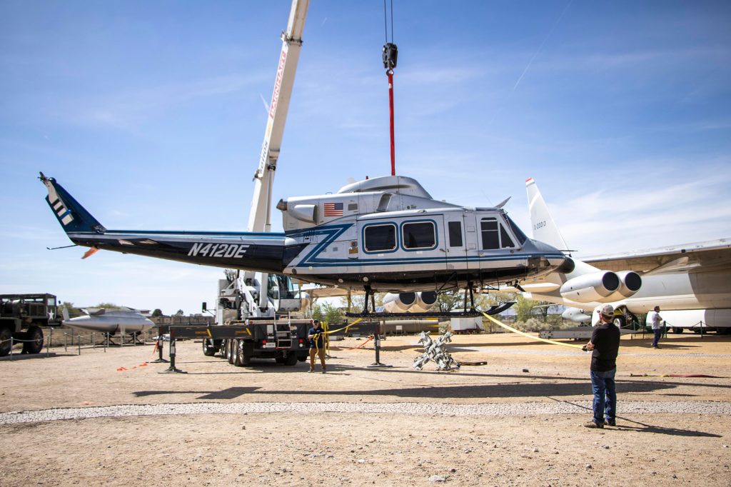 <strong>CLEARED FOR LANDING</strong> — A twin-engine Bell 412 helicopter is lowered into Heritage Park at the National Museum of Nuclear Science & History on March 24. The aircraft joins the museum’s fleet after a 30-year career supporting the NNSA Nuclear Emergency Support Team, providing radiological surveillance at presidential inaugurations, Super Bowls and political conventions. Sandians have contributed technical expertise to NEST’s mission throughout the program’s history. (Photo by Lyndsee Cantly, National Museum of Nuclear Science & History)