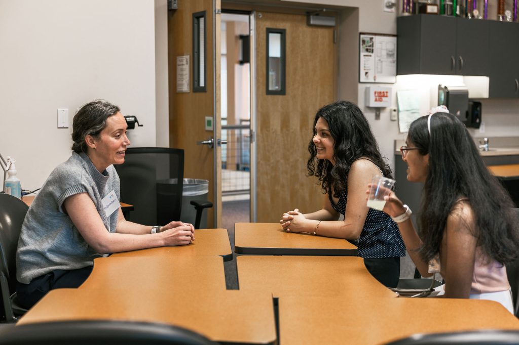 <strong>SHARING STEM</strong> — Manager Emily Hollister, left, mentors two award recipients. (Photo by Spencer Toy)