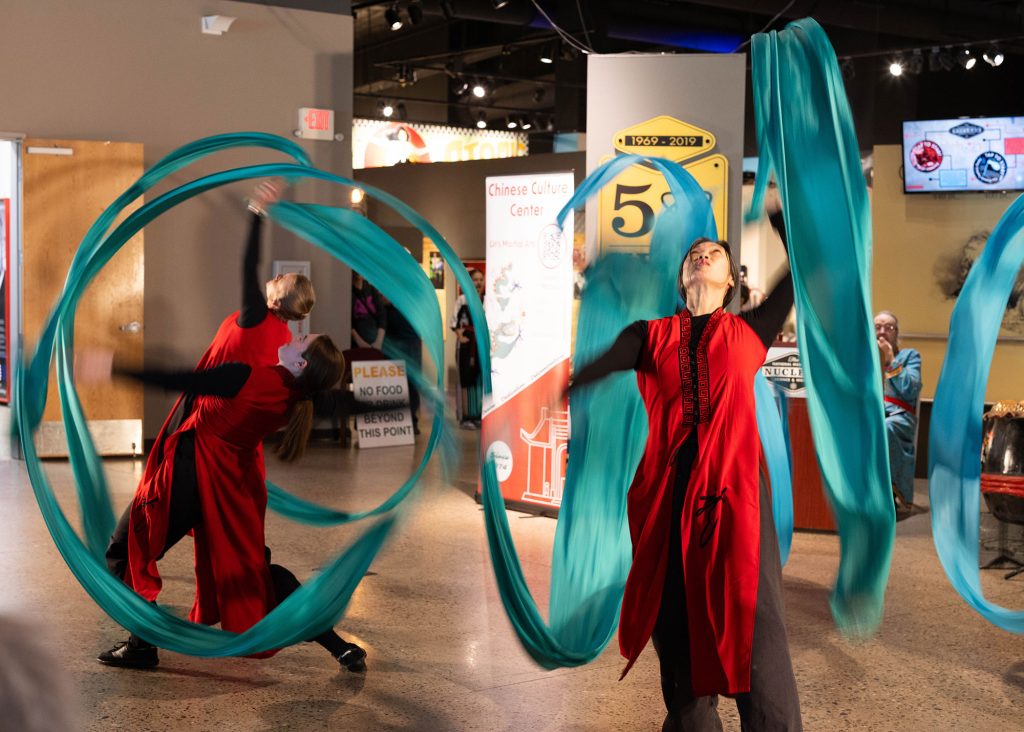 <strong>RIBBON DANCE</strong> — Members of the Albuquerque Chinese Folk Dance Ensemble perform the fast-paced and intricate ribbon dance at the 2026 Asian American and Pacific Islander Heritage festival, hosted by Sandia and the National Museum of Nuclear Science & History.