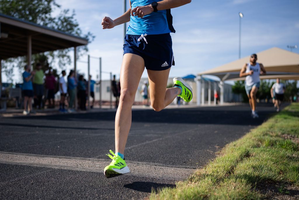 <strong>EVERY SECOND COUNTS</strong> — Grace Driskill crosses the finish line first in the women’s race at the Sandia New Mexico DOE Mile event on May 13. The DOE Mile began 11 years ago at Sandia California and has evolved into an event that spans all 17 national labs.