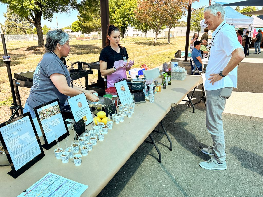 <strong>SALAD WITH ‘FRIENDS’</strong> —<br>Maria Montes and Gina Madison serve samples of Jennifer Aniston’s viral salad recipe. (Photo by Lea Blevins)
