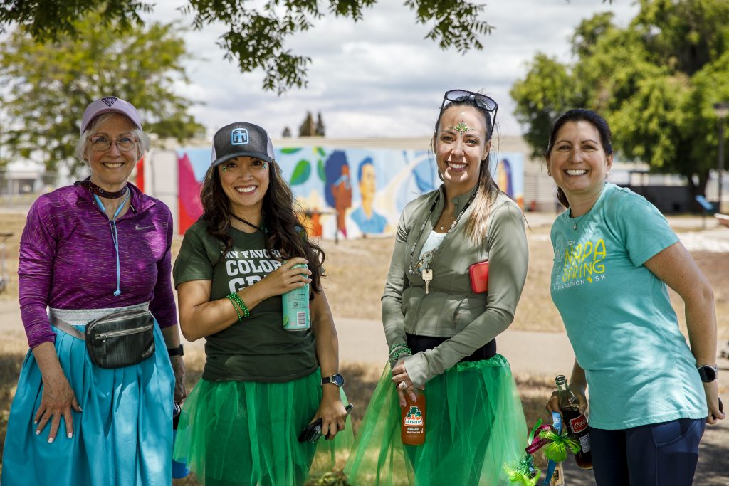 <strong>MILES OF SMILES</strong> — From left, Director Sarah Allendorf, Director Trish Benguerel, Acting Senior Manager Amy Valles and Human Resources Specialist Traci Ryan celebrate walking the DOE Mile in Livermore. (Photo by Spencer Toy)