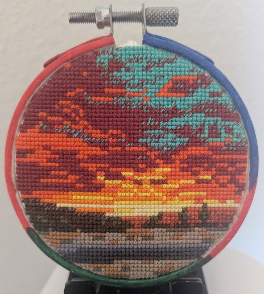 <strong>EUBANK SUNRISE</strong> —Cross-stitch by mechanical engineer Carol Young.