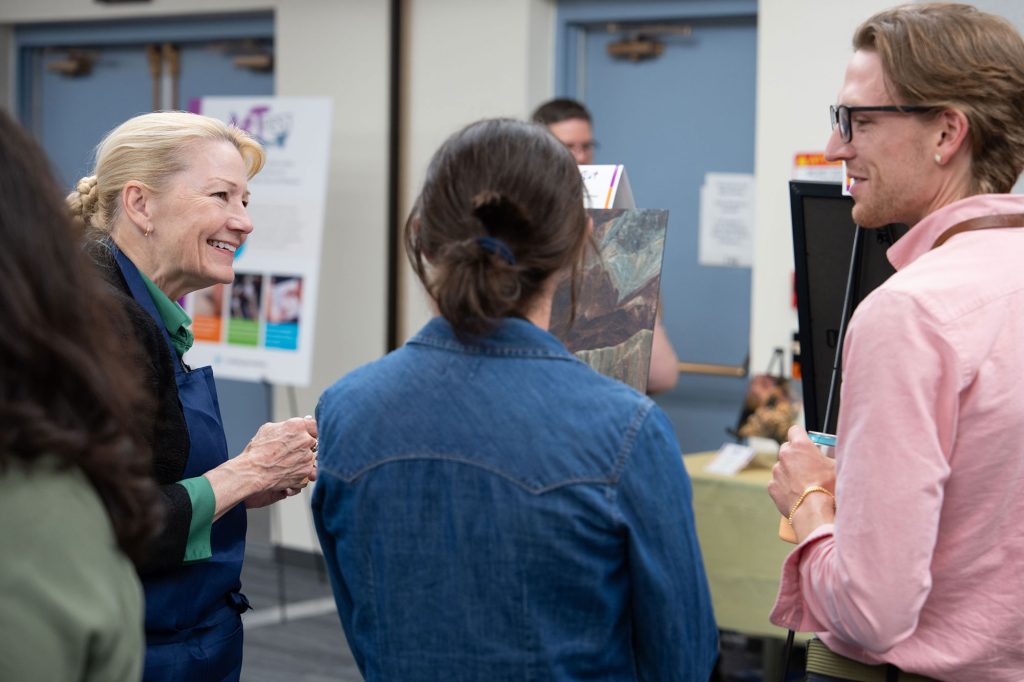 <strong>ART AND CONNECTION</strong> — Labs Director Laura McGill, left, connects with staff members during Art Fest. (Photo by David Lienemann)