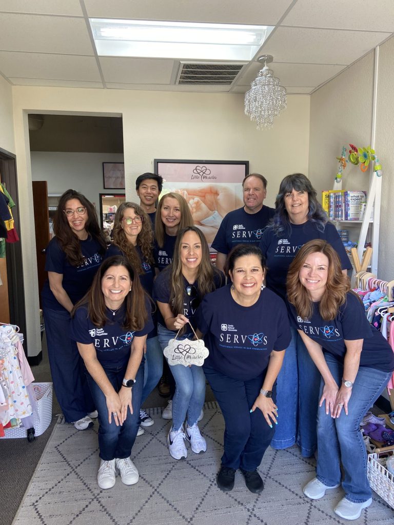 <strong>TEAMWORK</strong>&nbsp;—&nbsp;Managers and staff pose at Little Miracles after assembling baby supply kits for distribution to mothers and infants. (Photo courtesy of Meagan Brace)
