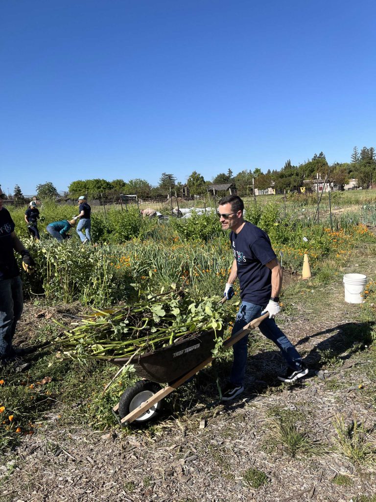 <strong>ON A ROLL</strong> — Senior manager Brian Wills transports plant material to the compost pile at Fertile Groundworks. (Photo by Amelia Harrison)