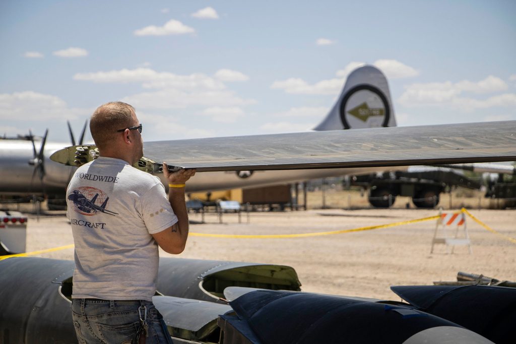 <strong>ASSEMBLY REQUIRED</strong>&nbsp;—&nbsp;A member of the Worldwide Aircraft Recovery team holds up the wing of the U-2 Dragon Lady as it’s attached to the fuselage during assembly of the plane in Albuquerque on May 22.&nbsp;(Photo by Lyndsee Cantly, National Museum of Nuclear Science & History)