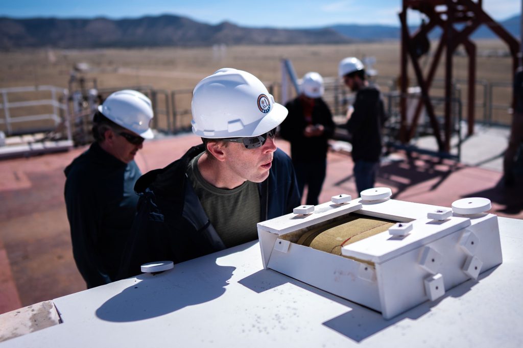 <strong>WOW FACTOR&nbsp;</strong>—&nbsp;Lockheed Martin engineer Derek Shannon checks a sample of heat shield material before a test at Sandia’s National Solar Thermal Test Facility. (Photo by Craig Fritz)