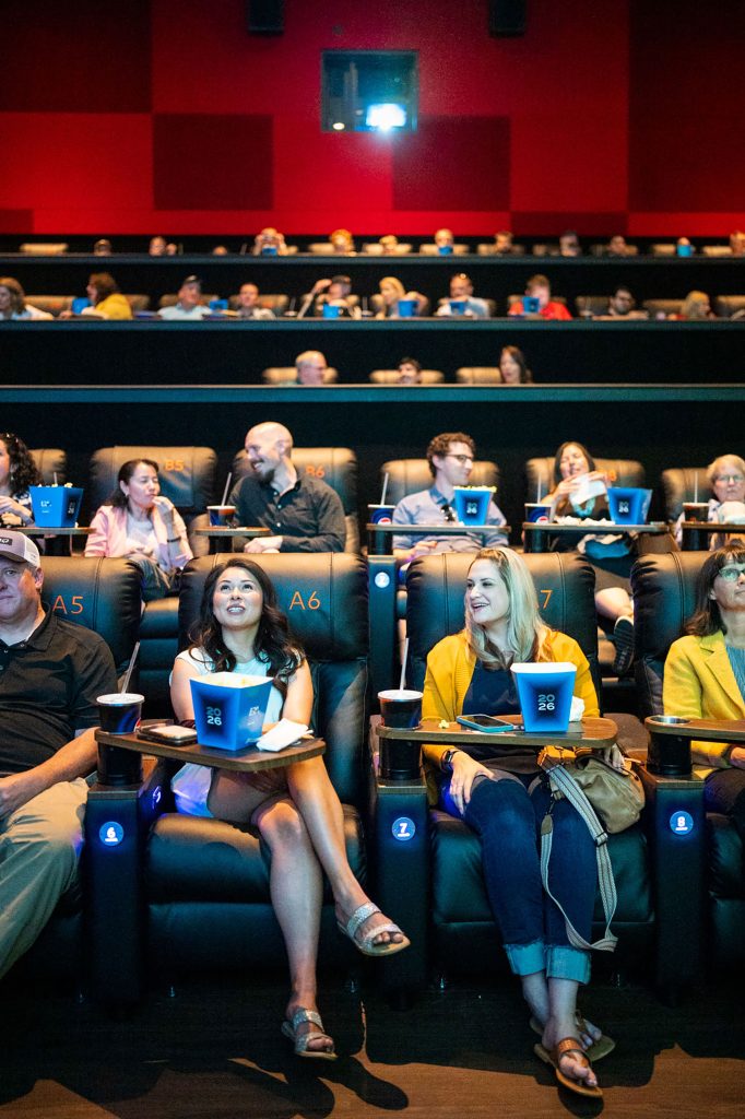 <strong>SHOWTIME</strong> — Project manager Savannah Torres, left, and program communications specialist Lyndsy Ortiz snag front row seats at the annual New Mexico Employee Recognition Awards on May 14. This year, Sandians gathered at Regal Winrock Stadium 16 in Albuquerque for a movie theater-style experience celebrating Sandia’s best work from 2025 and honoring the staff who made it happen. Watch Lab News for full coverage of the New Mexico and California events, to be published this summer. (Photo by Craig Fritz)