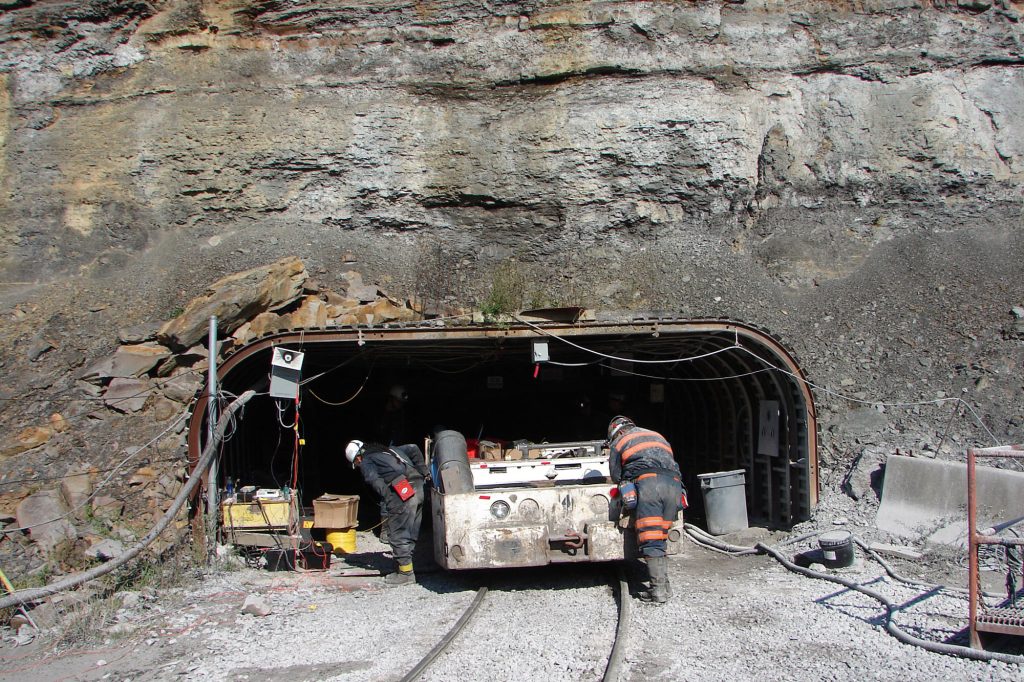 <strong>MINE ENTRANCE</strong> — Sandian Dawna Charley, left, and a Sago miner work with a vehicle, called a mantrip, before it enters the mine as part of experiments the Labs personnel conducted at the site in November 2006. (Photo from Sandia archives)