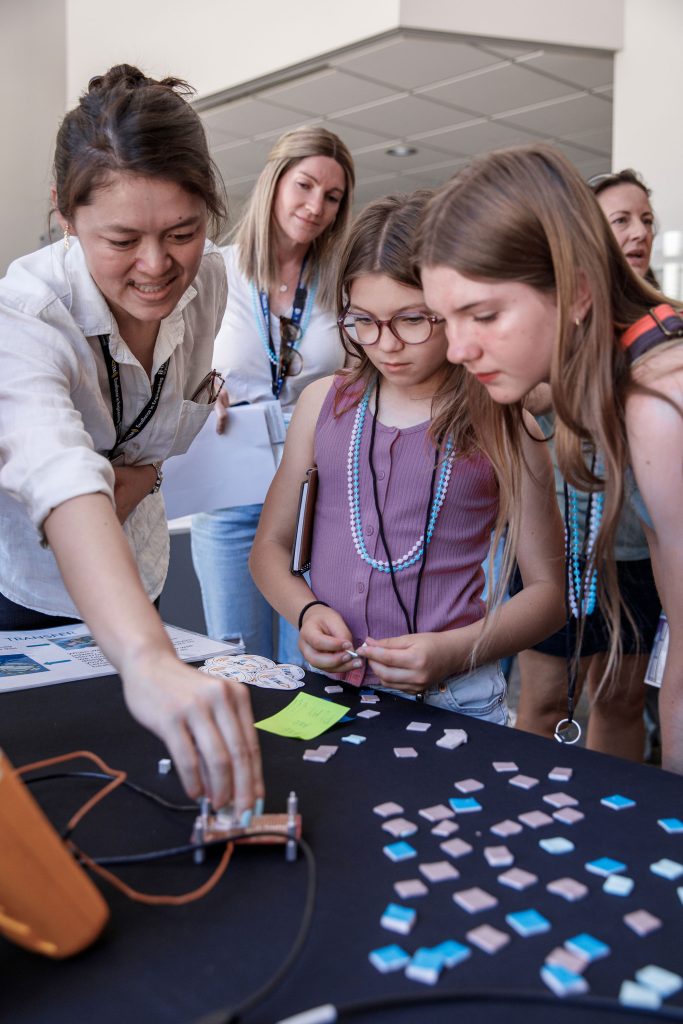 <strong>HEATING UP</strong> — Melissa Ng leads the Telemetry Heat Management activity during Kids Day in California. Students explored how different materials absorb and spread heat. (Photo by Spencer Toy)
