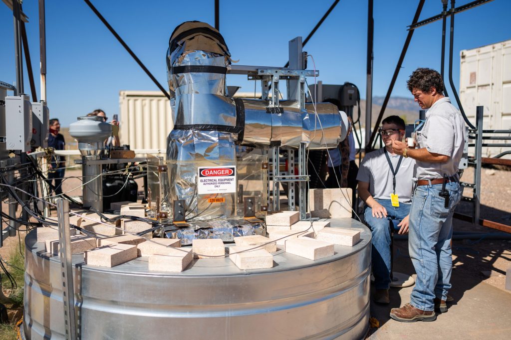 <strong>SUCCESSFUL ROAST</strong> — Sandia engineer Luke McLaughlin talks to colleague Henk Laubscher during a coffee roasting experiment at the National Solar Thermal Test Facility at Sandia. The experiment used stored solar energy in a testbed to heat up the coffee roaster, as part of project with Michael Thomas Coffee.