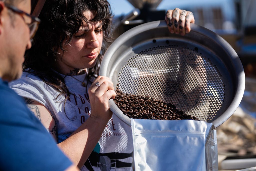 <strong>CUP OF SUNSHINE</strong> — Kate Sweeney from Michael Thomas Coffee empties coffee beans that were roasted using heat from a thermal testbed at Sandia as part of Cooperative Research and Development Agreement.