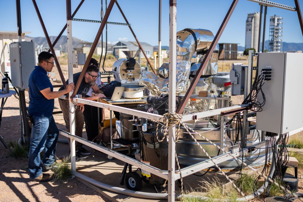 <strong>EXPERIMENT IN ACTION</strong> — Sandia engineer Ken Armijo and business owner Michael Sweeney watch temperatures displayed on a laptop while roasting coffee using heat released from a testbed at the National Solar Thermal Test Facility at Sandia.
