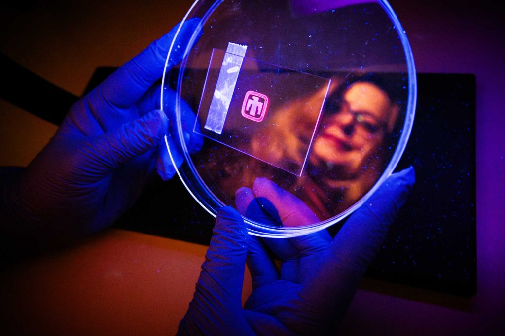 <strong>FOILING FRAUD</strong> — Sandia material scientist Dorina Sava Gallis holds an optical tag containing printable security ink designed to detect counterfeit goods. (Photo by Craig Fritz)