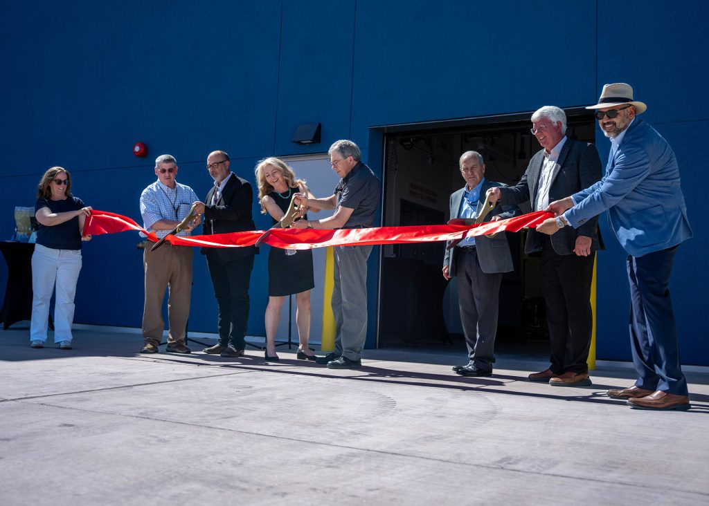 <strong>THREE, TWO, ONE</strong> — From left, Sandia’s Caren Wenner, Chris Gresham, Wes Bruno, Amy Allen, Ray Carey, Associate Labs Director Steve Girrens, NNSA Sandia Field Office Manager Daryl Hauck and Lorenzo Gutierrez participate in the ribbon-cutting ceremony at the new Energetic Manufacturing Science and Technology Facility June 30. The 10,000-square-foot facility will provide Sandia with the capability to produce critical war-reserve components for nuclear deterrence systems while developing cutting-edge manufacturing capabilities.