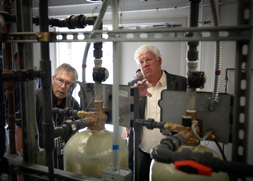 <strong>STRATEGIC INVESTMENT</strong> — Sandia’s Ray Carey, left, leads Daryl Hauck, manager of the NNSA Sandia Field Office, on a tour of the new Energetic Manufacturing Science and Technology Facility. Located just west of the Explosives Components Facility, the new building was designed with 6,000 square feet of configurable space to support changing mission needs in the energetic manufacturing space. Sandia leaders call it a strategic investment for nuclear deterrence. Workers start using the space in mid-July.