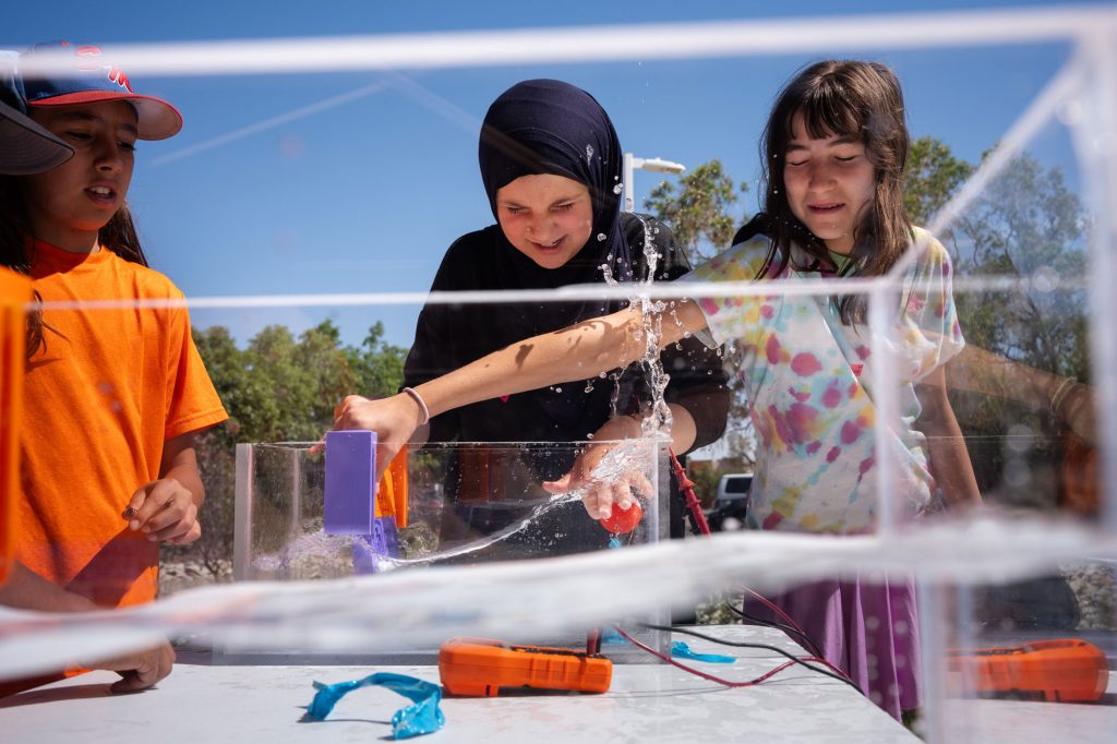 <strong>ENERGY SURPRISE</strong> — From left, Jasper Otero, Nazha Ali and Linnea Warrick experience how much power is made by their wave energy converter during summer camp at Explora Science Center and Children’s Museum on June 3.