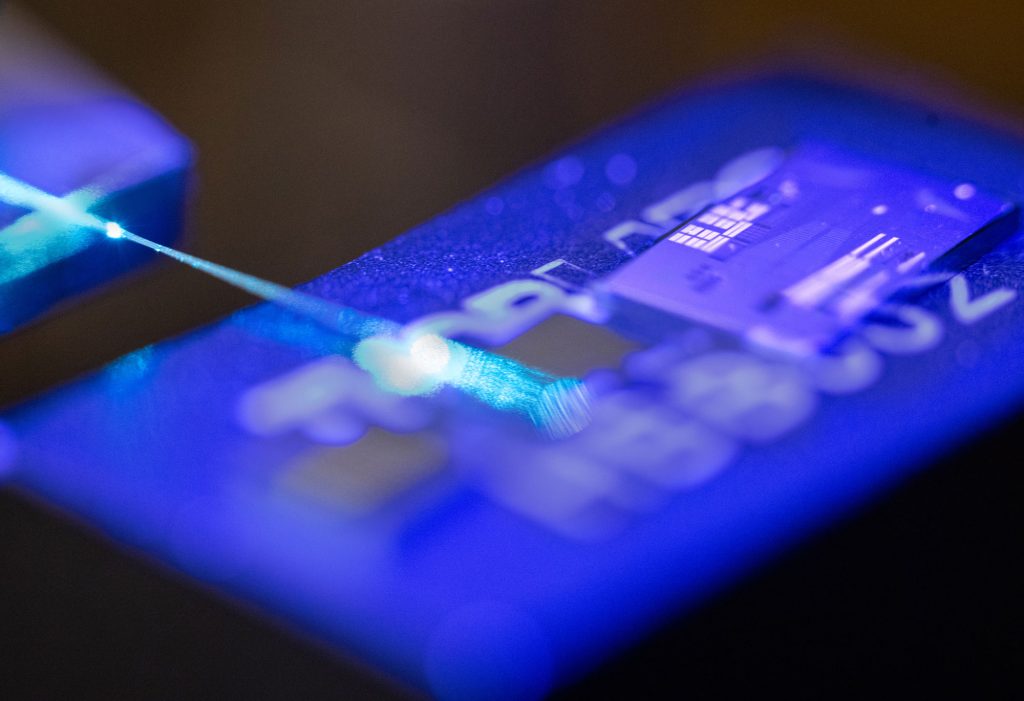 <strong>PIC-TURE THIS</strong> — A laser illuminates the surface of a photonic integrated circuit, or PIC, at Sandia.