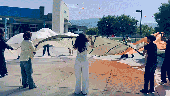 <strong>WAVES IN ACTION</strong> — Students experience waves in an experiment using a parachute and different-sized balls. (Photo and video by Shaina Saint-Lot)