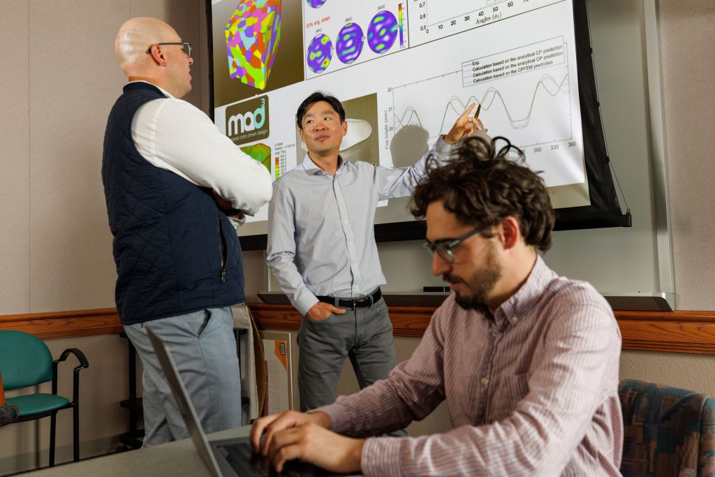 <strong>MAD³ SCIENTISTS</strong> — From left, David Montes de Oca Zapiain, Hojun Lim and Benjamin Greene chart the results and capabilities of machine-learning algorithm MAD³ created to accelerate materials simulation.&nbsp;(Photo by Bret Latter)