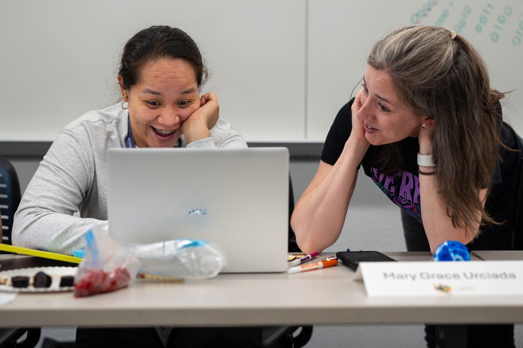<strong>TEACH THE TEACHERS</strong> — Educator Mary Grace Urciada, left, and Sandia physicist Meagan Ivory discuss quantum entanglement and superposition at Quantum Computing, Mathematics and Physics, or QCaMP, June 25 in a classroom at the University of New Mexico. QCaMP has grown into a weeklong camp for teachers in 15 states and a four-week camp for students in New Mexico and California.