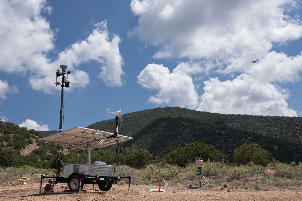 <strong>DRONE DETECTION </strong>— The portable sensor trailer system is set up with a telescoping pole, equipped with radar and high-definition cameras to detect drones during an exercise for the military. Ground surveillance radar is off to the right. (Photo by David Lienemann)