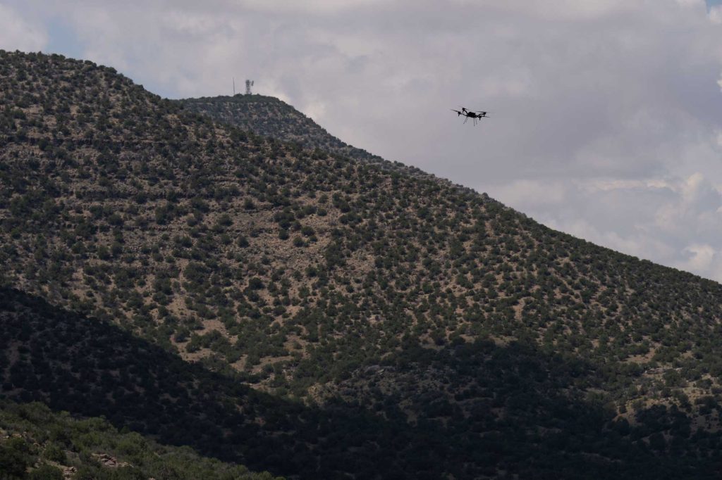 <strong>UP AND AWAY </strong>— A drone flies over the mountains, mimicking conditions often found along the U.S. Mexico border, during a Sandia-led exercise. The goal was to test rapidly deployable technology for border security and military applications. (Photo by David Lienemann)