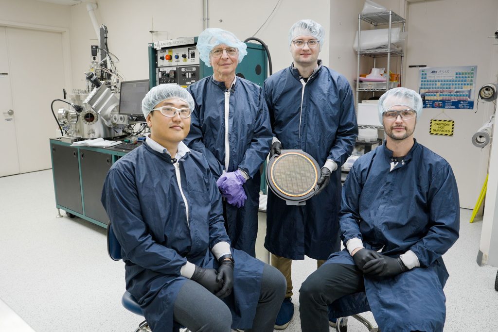 <strong>ETC TEAM</strong> — From left, Sangheon Oh, Alec Talin, Adam Gross and Elliot Fuller circle around an array of ETCRAM chips they engineered. (Photo by Ruth Frank)