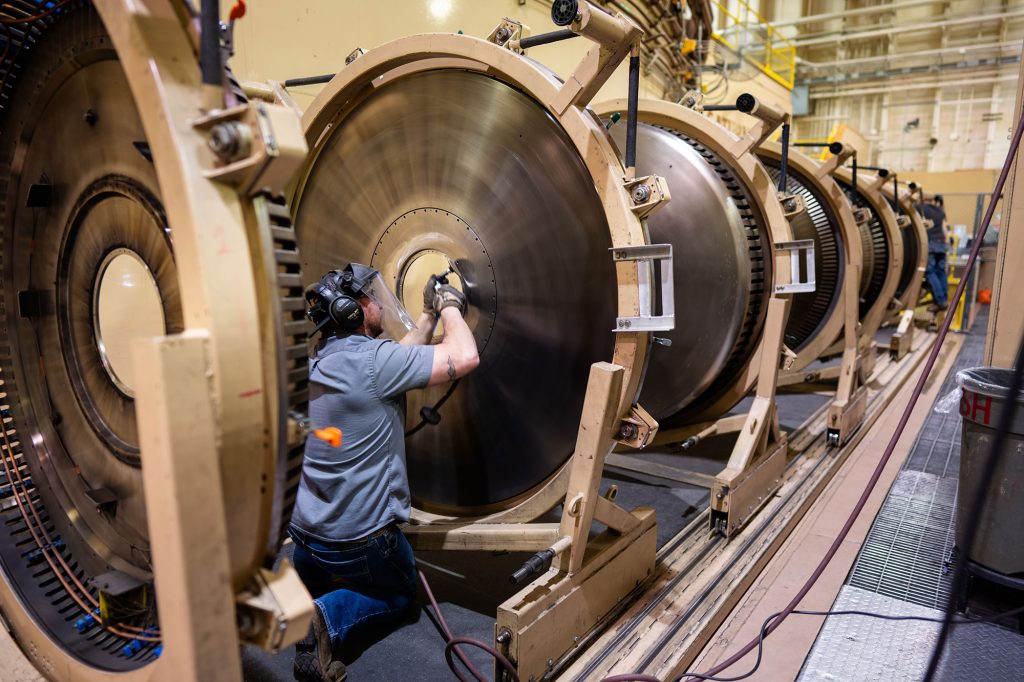 <strong>CLEAN SHOT</strong> — Randy Peacock grinds metal slag from a magnetically insulated transmission line of the Saturn accelerator following a test. Sandia is a multifaceted research and engineering laboratory, which enables employees to build career paths that can span multiple areas.