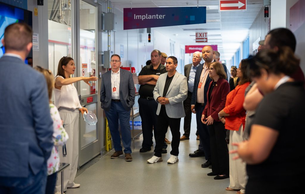 <strong>MESA VISIT</strong> — Senior manager Catherine Green, left, leads members of the Aerospace States Association, including New Mexico Lieutenant Governor Howie Morales, center, on a tour of the Microsystems Engineering, Science and Applications center on Aug. 20. The Aerospace State Association comprises state lieutenant governors, state legislators and professionals from government, industry and academia. The group also toured Center for Advanced Manufacturing and Innovation, or CAMINO, and the Thermal, Fluid and Aeroscience Lab. (Photo by Craig Fritz)