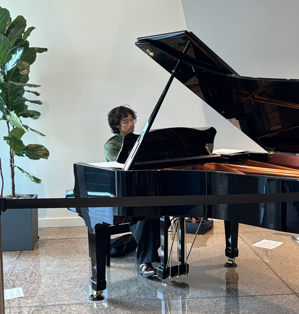 <strong>THE RIGHT NOTE</strong> — Jeremy Espano uses free time at the 2026 Energy Storage Program Meeting and Peer Review, where he presented research, to practice piano before an informal performance for those in attendance. (Photo by Mattie Hensley)
