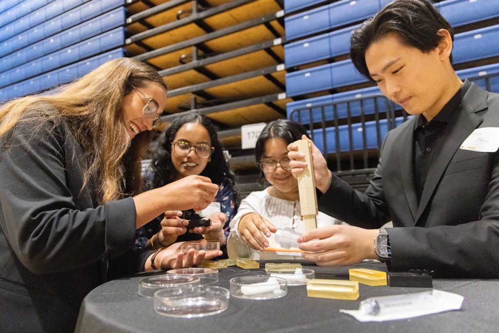 <strong>CREATIVE COMPETITION</strong> — A team of biomedical engineering students demonstrate their senior research project during the Engineering Design Showcase. (Photo by Mario Rodriguez, University of California, Davis)