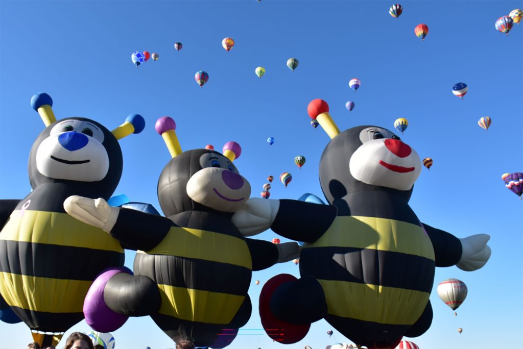 <strong>MEANT TO BEES </strong>— Three “Little Bees” hot-air balloons take to the sky during a Mass Ascension event at Balloon Fiesta. Sandians Tony Grabara and April Barrick are on the “Little Bees” crew and working toward their own pilot licenses. (Photo courtesy of Tony Grabara)