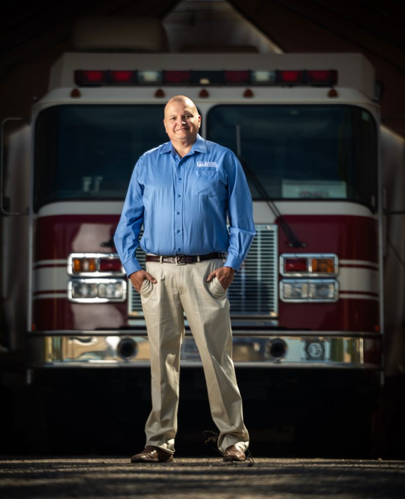 <strong>PROTECT PEOPLE FIRST</strong> — Tomas Sanchez, Sandia New Mexico's fire marshal, stands in front of a fire engine at Kirtland Air Force Base Fire Department. Sandia fire marshals partner with Kirtland Air Force Base in New Mexico and Alameda County in California to ensure fire protection across both sites. (Photo by Craig Fritz)