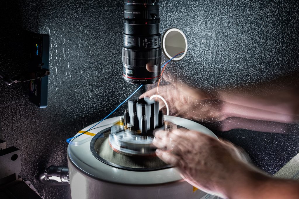 <strong>LAST STOP ON ROTATION</strong> — A shaker table test mimics transportation and flight environments. Mechanical engineer Lucas Spies performs component testing to determine how such an environment affects the integrity of the component. Lucas completed MechREP before joining Sandia in his current role.