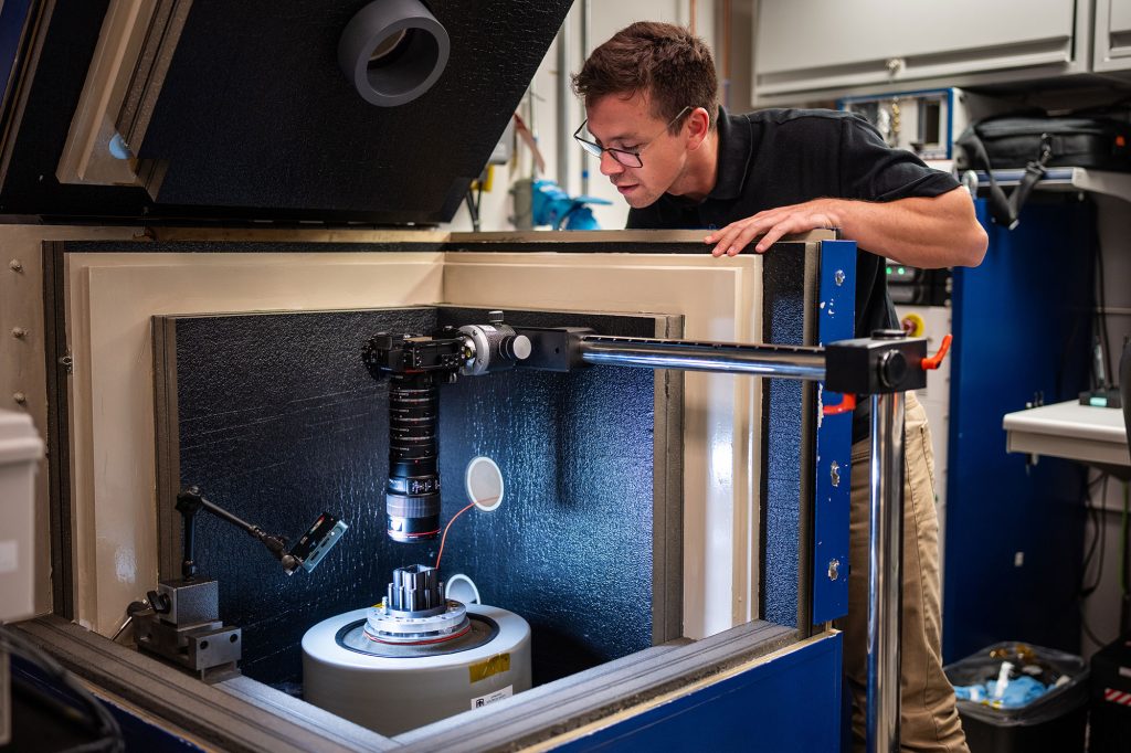 <strong>SHAKE 'N TEST </strong>— Mechanical engineer Lucas Spies places a component on top of a shaker table before starting a test that mimics transportation and flight environments. Lucas completed the rotational program, known as MechREP, before joining the mechanisms team.