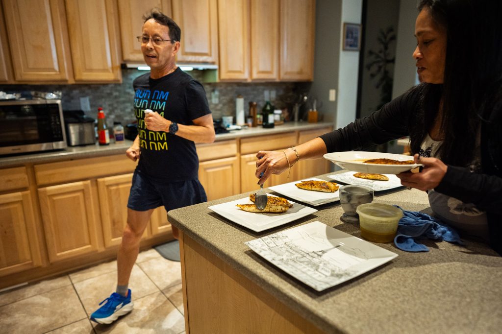 <strong>38 LAPS</strong> — Sandia mechanical engineer Brian Johnson loops around his kitchen island as the second to last step of his indoor course. Brian has run at least one mile every day for 12-and-a-half years.